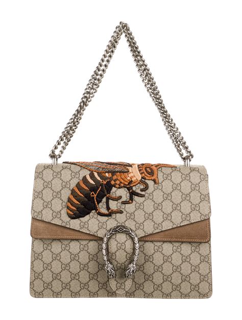 gucci top with bees on shoulder|Gucci shopping bags.